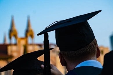 A person wearing a graduation cap and gown