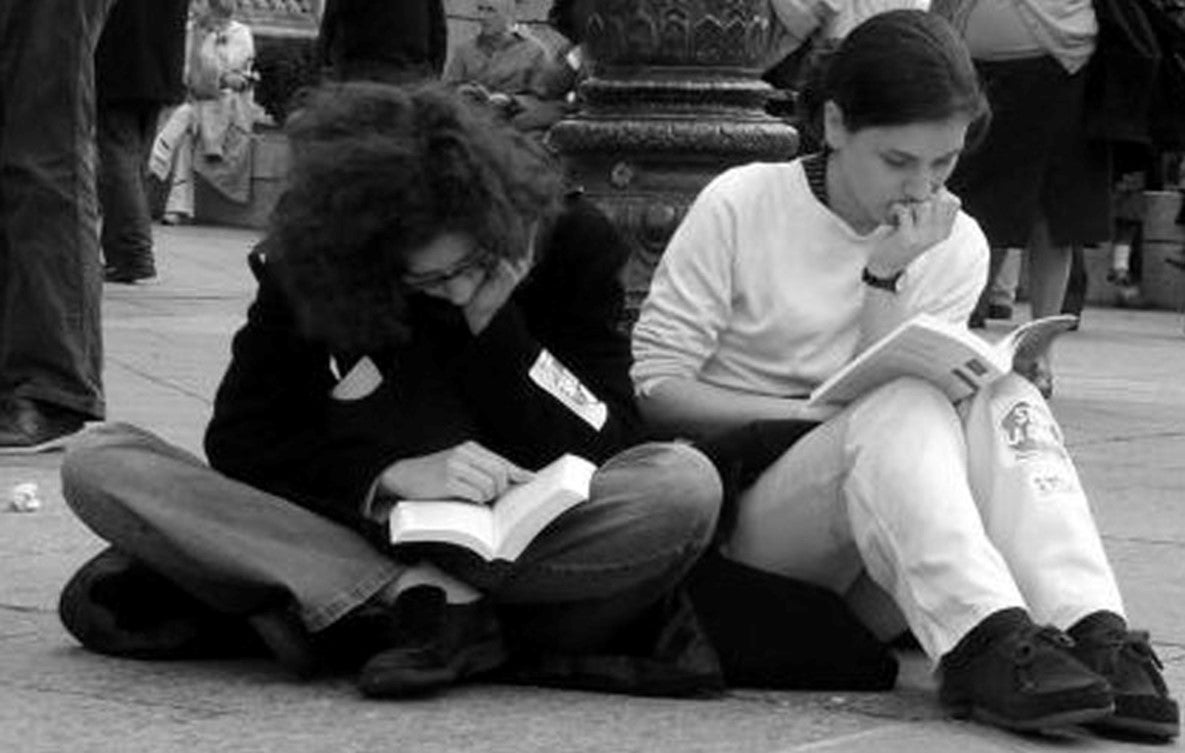 Black and white image of two women reading