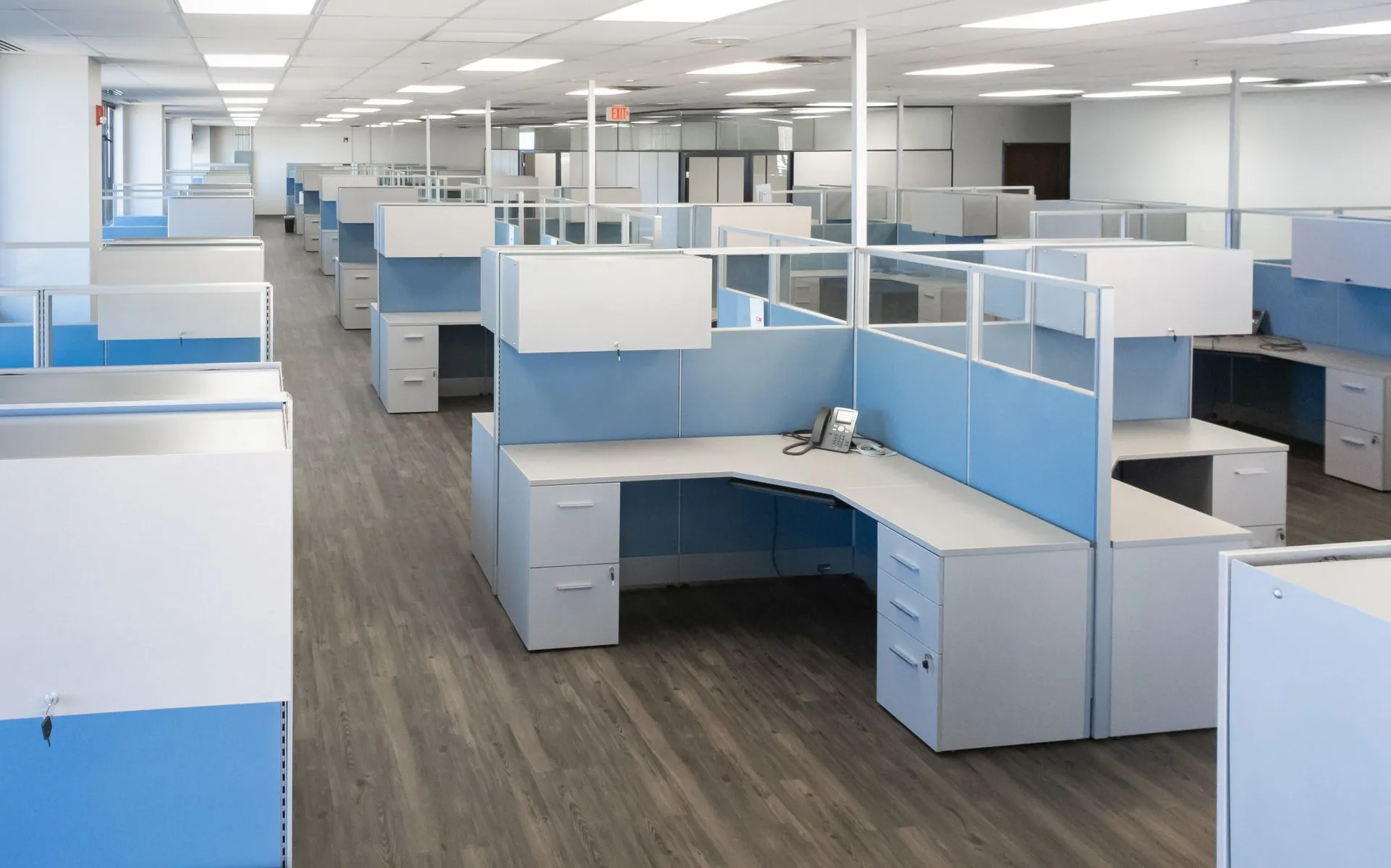 rows of cubicles and tables in an office
