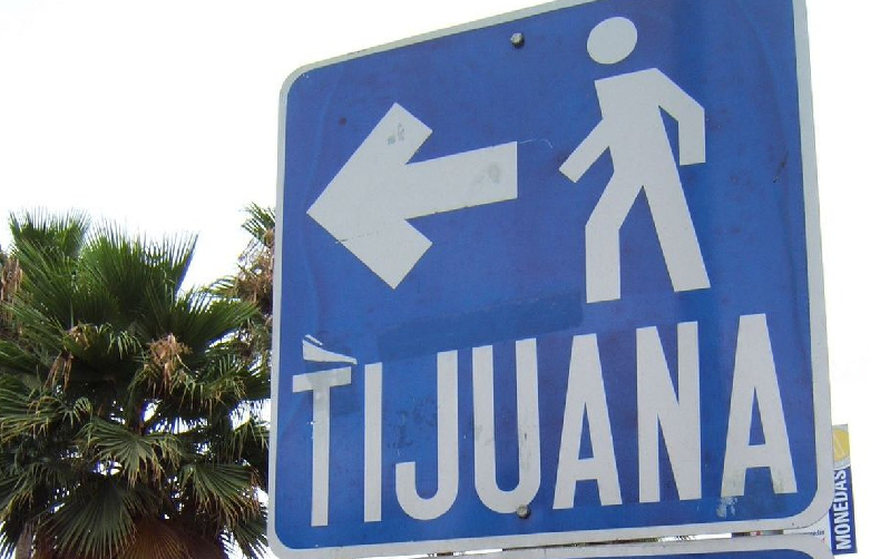 Sign pointing to Tijuana, Mexico near the US and Mexico border
